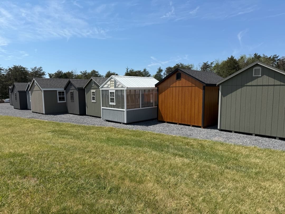 Row of Amish-built sheds on display at the Shenandoah Sheds lot